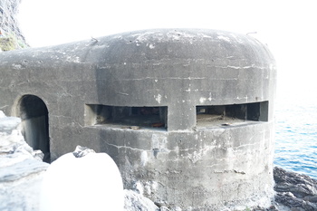 A WWII era bunker looks out on the water.